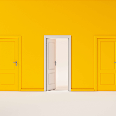 One white door opens amid a uniformly yellow wall lined with yellow doors One white door opens amid a uniformly yellow wall lined with yellow doors